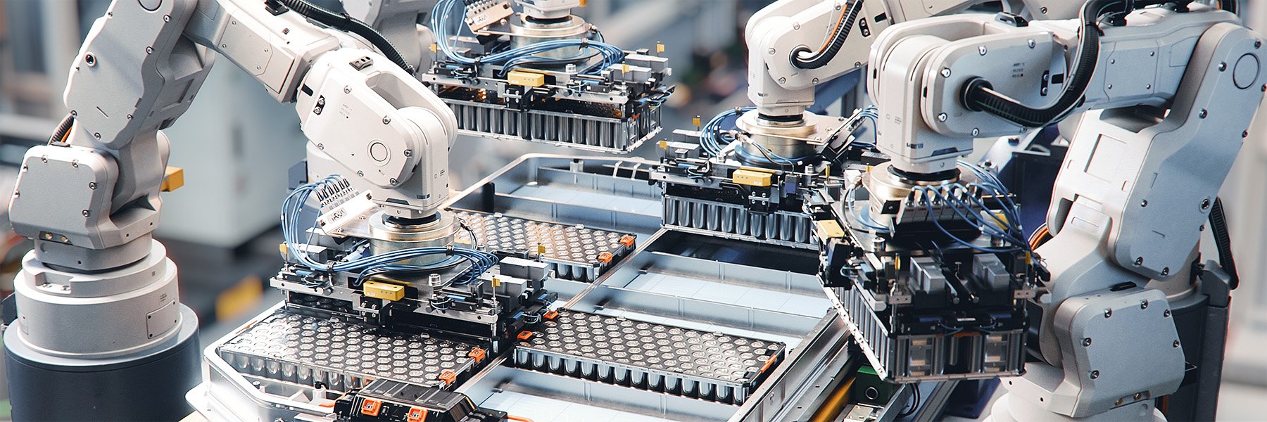 Robotic arms seamlessly transfer battery packs from the assembly line to the final production stage.